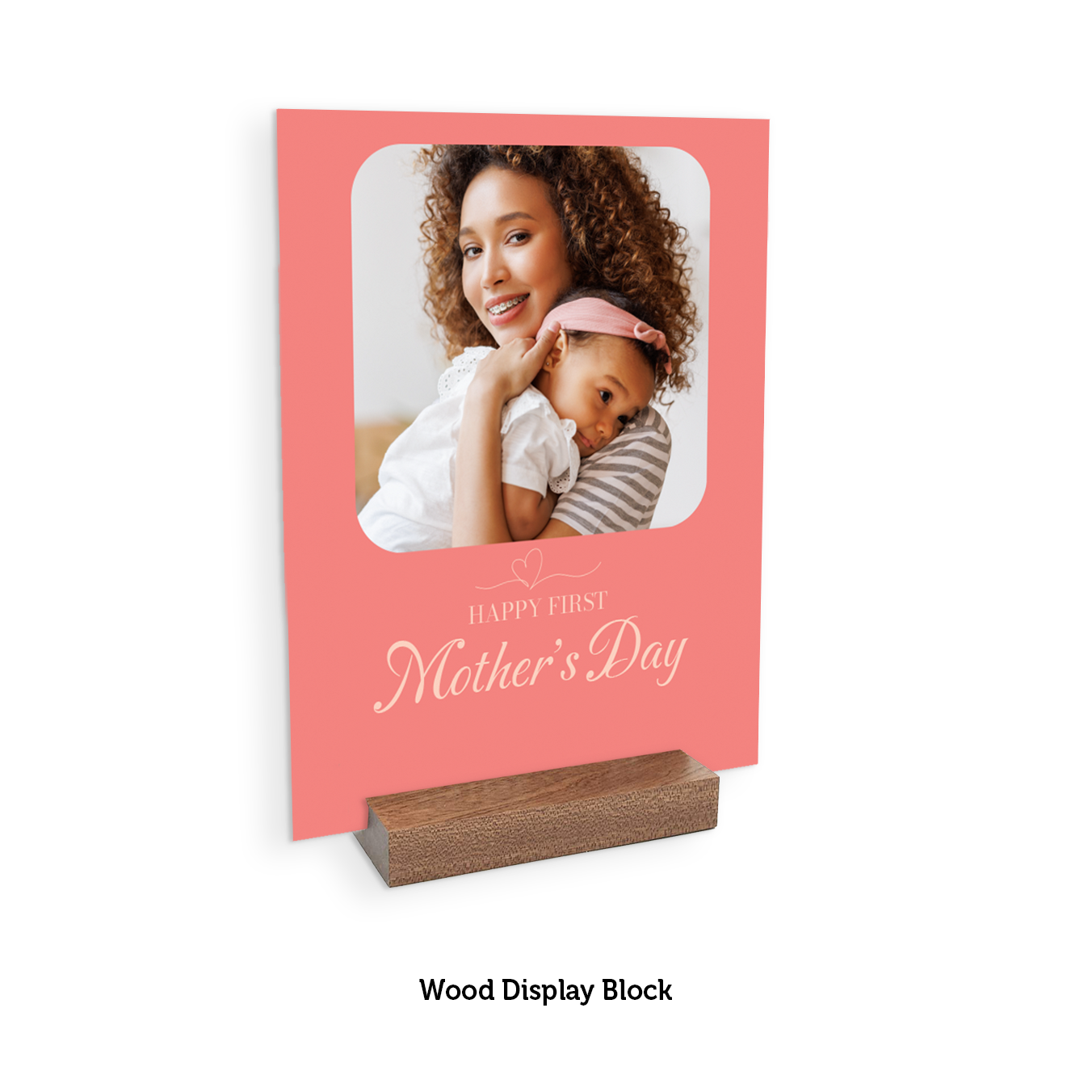Pink Mother's Day card with a photo of a woman and baby, displayed on a wooden block.