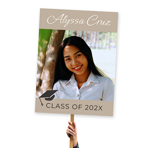 Personalized graduation sign featuring a graphic of a grad cap, name, and class year in a large format.