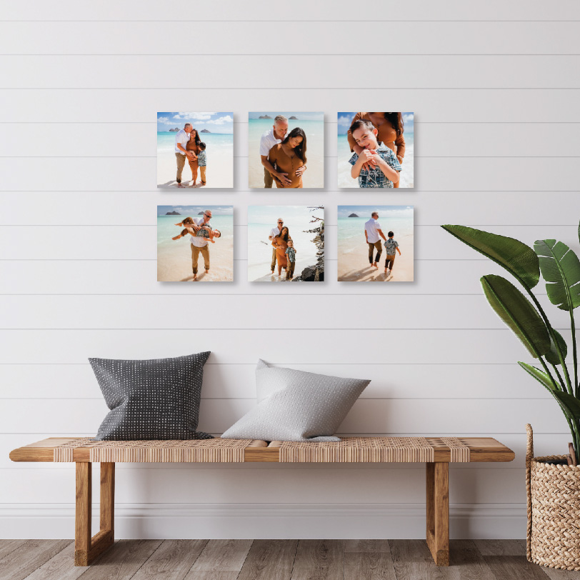 Six square photos of a family on a beach, featuring different poses and moments, displayed on a white wall.