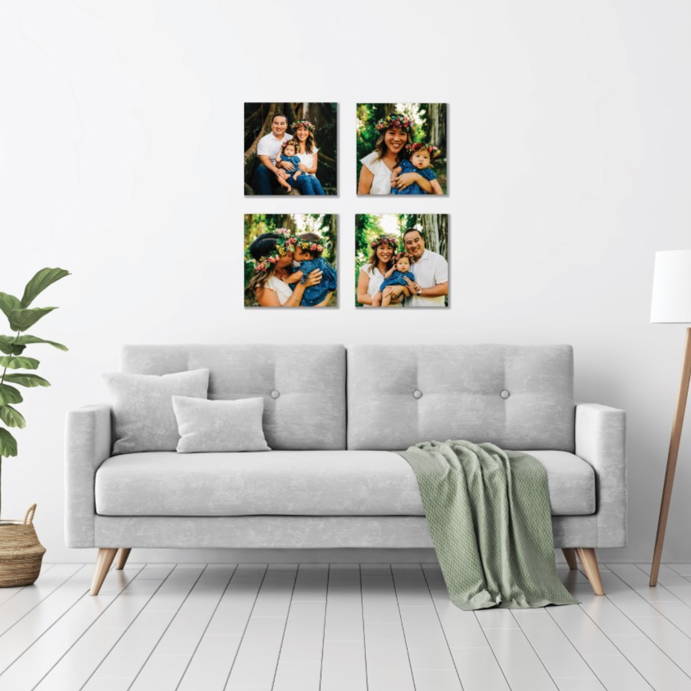 Four square framed photos of families, wearing flower leis, displayed on a wall above a light gray couch.